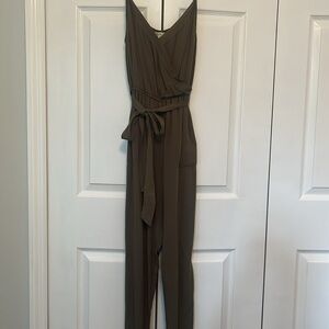 Olive green jumpsuit, v-neck with pockets and tie sash.